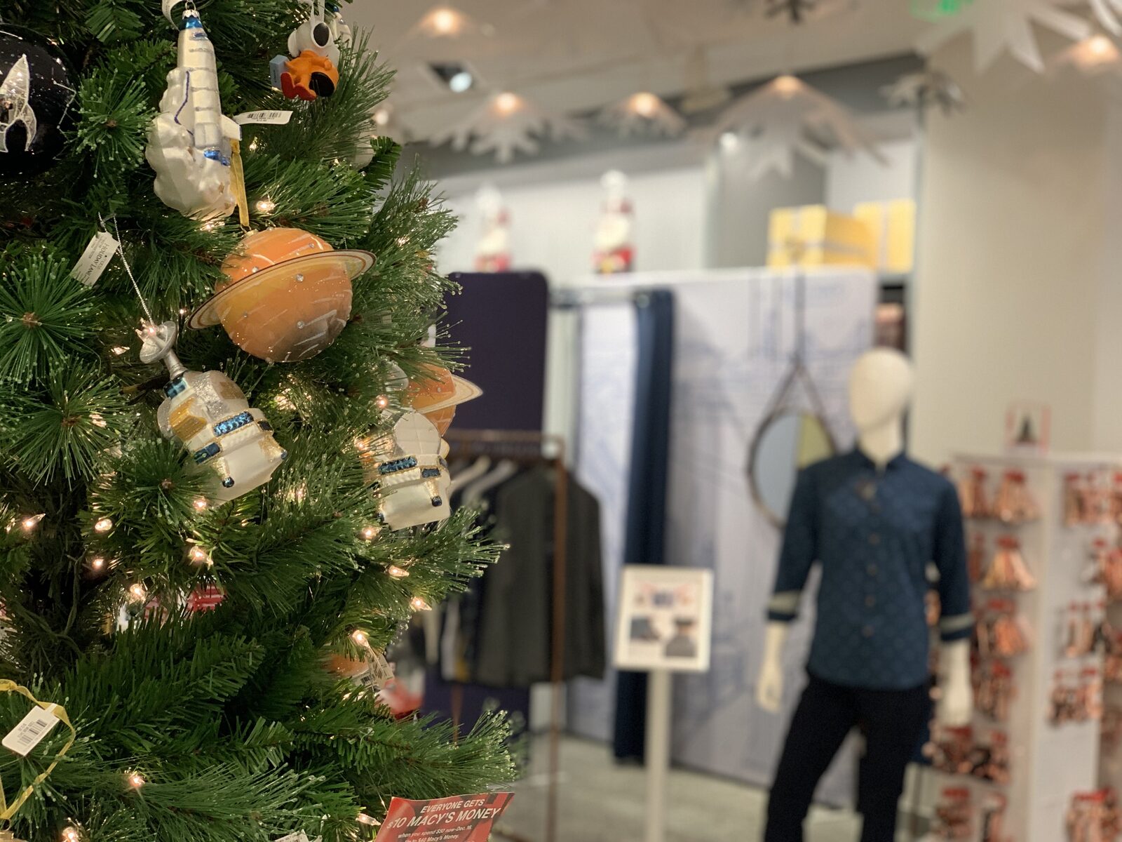 Macy's holiday display — Christmas tree with Cotton the First capsule in background