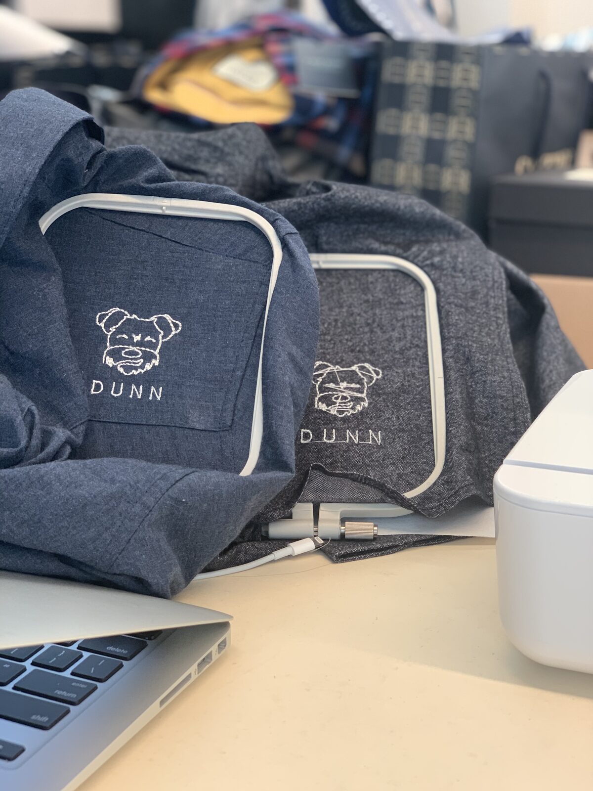 Embroidery machine stitching Dunn the Schnauzer onto two shirts